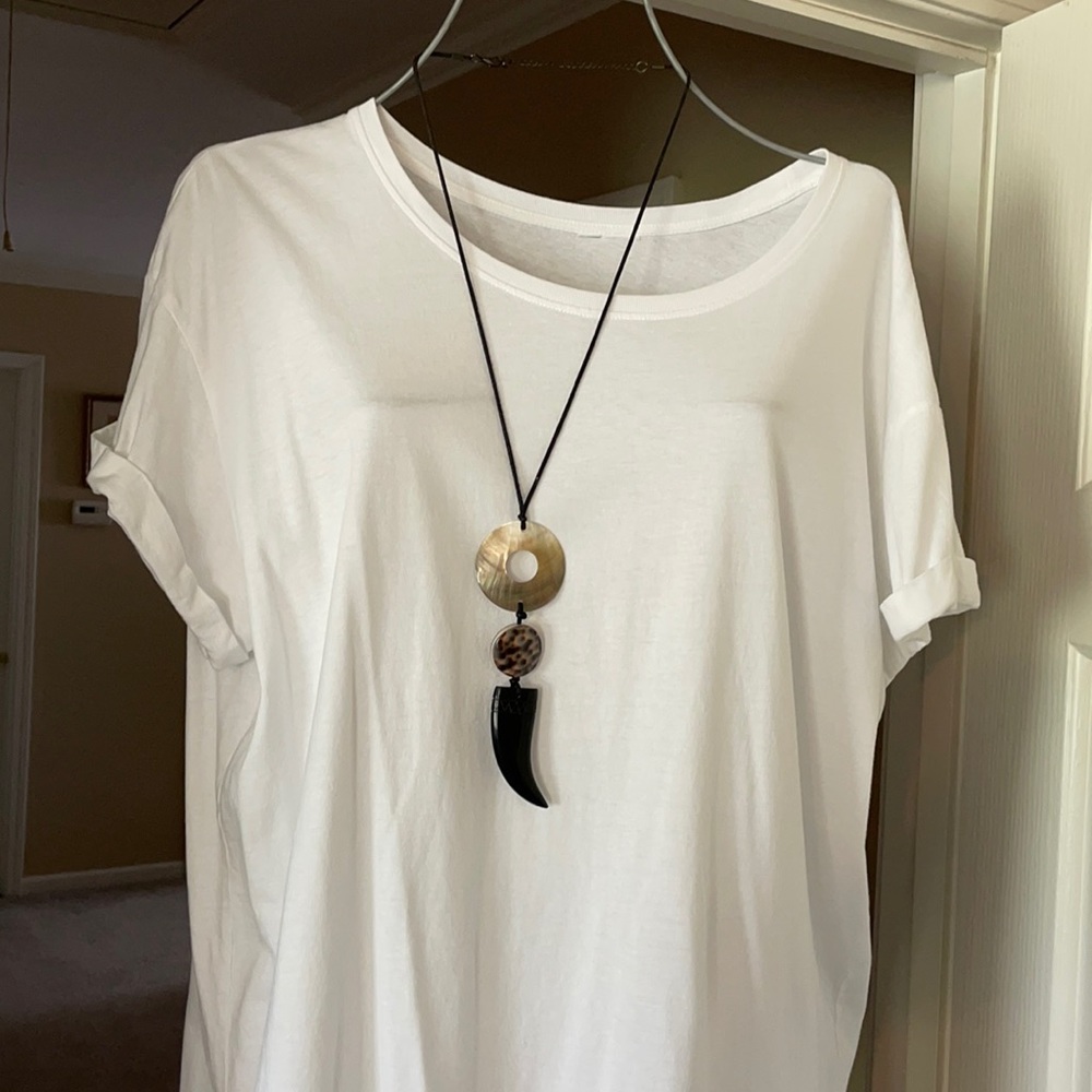 Polished sea shell and onyx bear claw necklace.